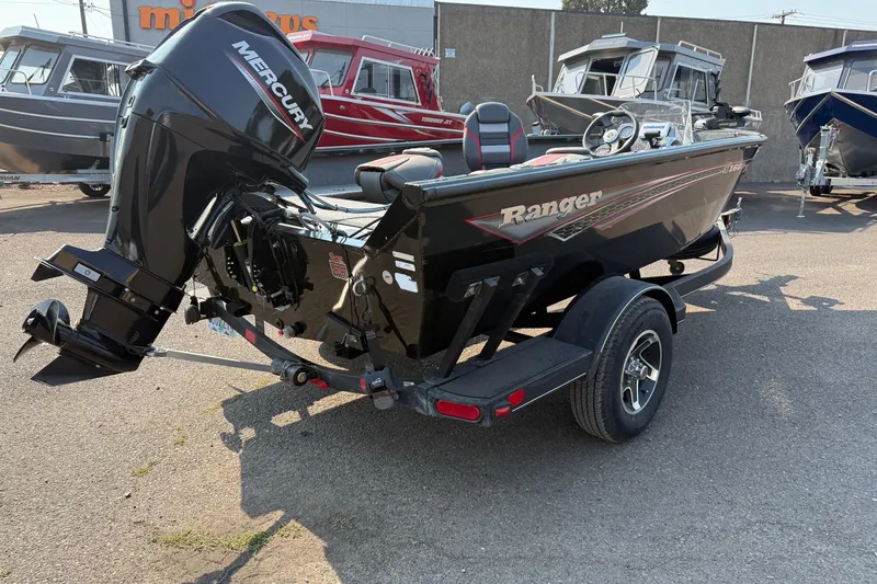 Slide: The Image of 2023 Ranger VS1665SC boat with Mercury engine, parked on a trailer in a dealership lot. - 3