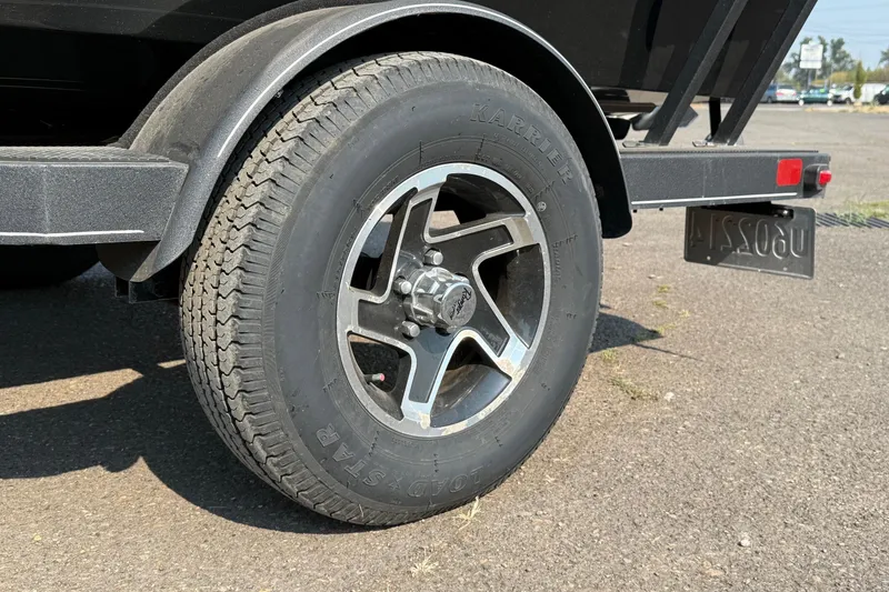 Slide: The Image of 2023 Ranger VS1665SC trailer wheel with Kenda Karrier tire on asphalt. - 8