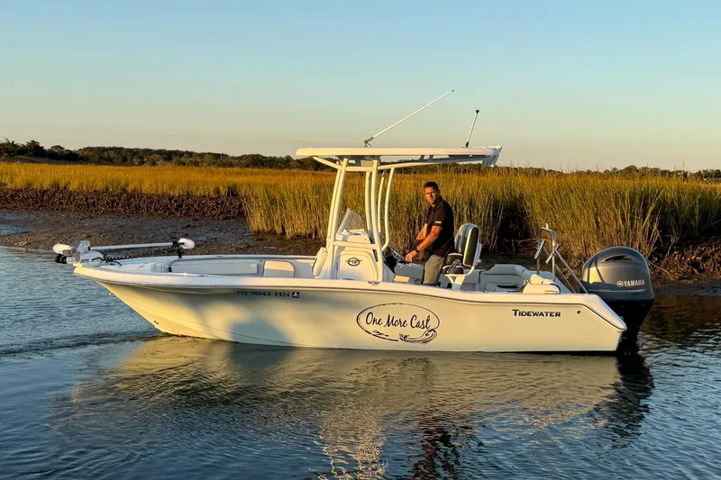 Slide: The Image of 2021 Tidewater 210 LXF boat cruising in calm waters at sunset. - 10