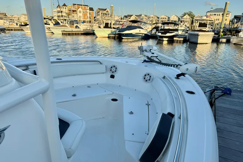 Slide: The Image of 2021 Tidewater 210 LXF boat on calm water at sunset. - 12