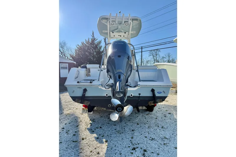 Slide: The Image of 2021 Tidewater 210 LXF boat with outboard motor, parked on gravel. - 27