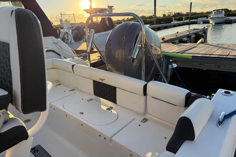 Slide: The Image of 2021 Tidewater 210 LXF boat cruising in calm waters at sunset. - 13
