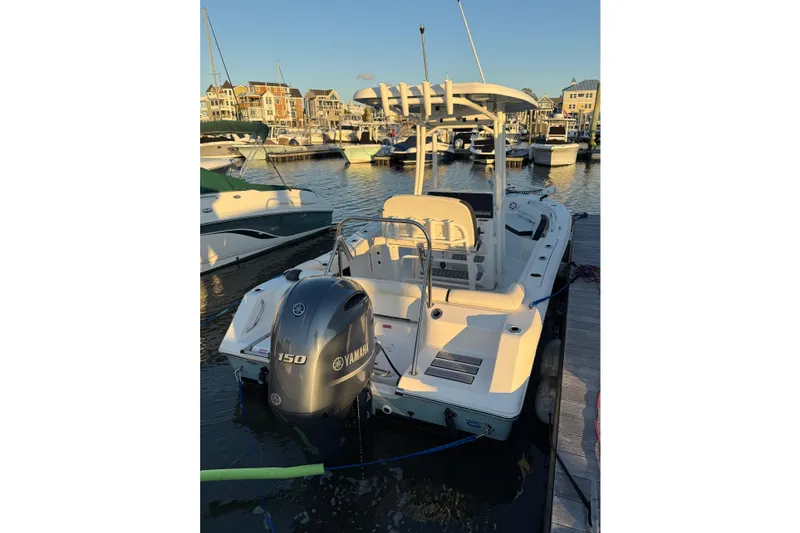 Slide: The Image of 2021 Tidewater 210 LXF boat on calm water at sunset, near marshland. - 14