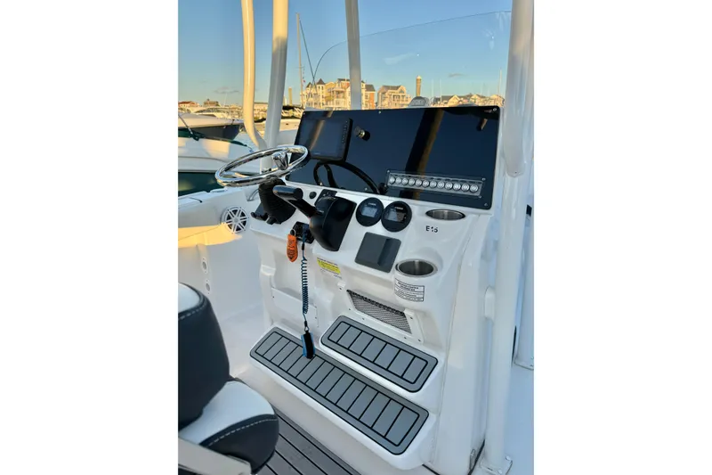 Slide: The Image of 2021 Tidewater 210 LXF boat interior at sunset, docked with visible outboard motor. - 18