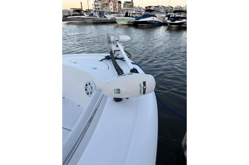 Slide: The Image of 2021 Tidewater 210 LXF boat docked, featuring a Yamaha outboard motor and T-top. - 20