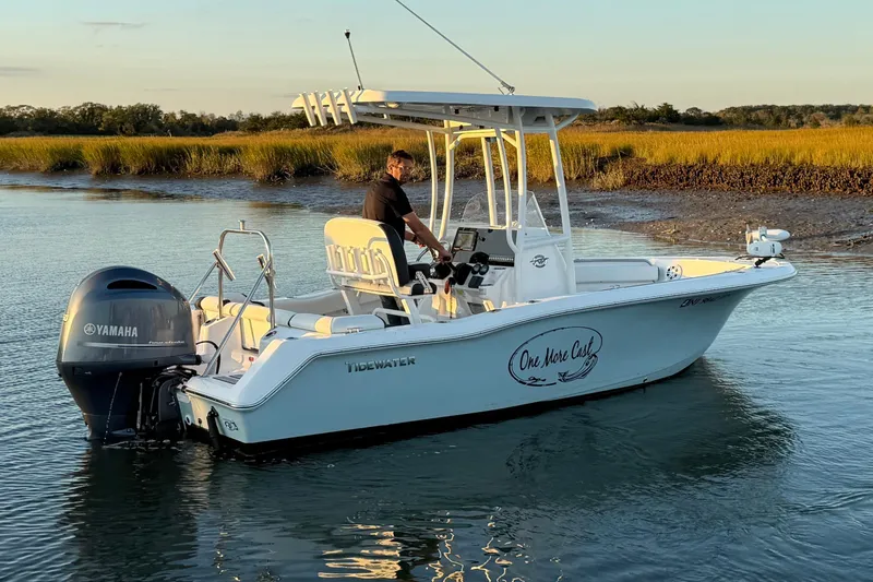 Slide: The Image of 2021 Tidewater 210 LXF boat on trailer, featuring sleek design and modern console. - 4