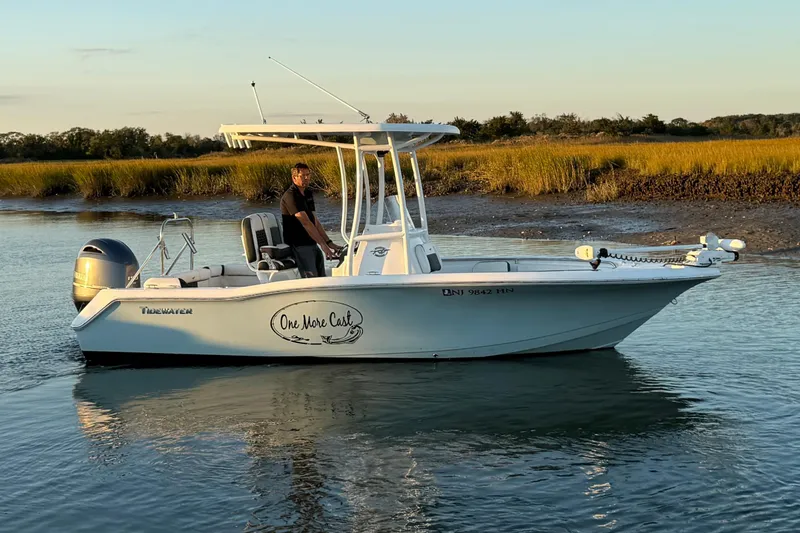 Slide: The Image of 2021 Tidewater 210 LXF boat on calm water with Yamaha engine. - 5