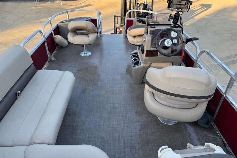 Slide: The Image of 2022 Sun Tracker Bass Buggy 18 DLX pontoon boat interior with seating and steering console. - 4