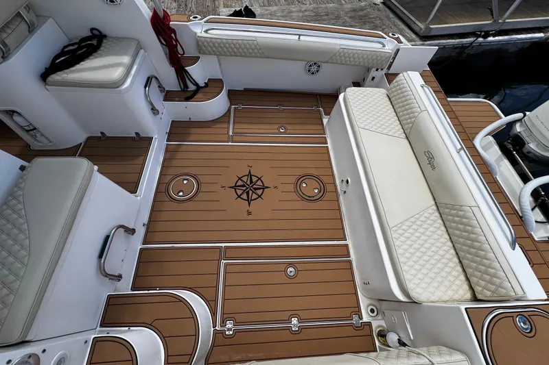 Slide: The Image of 2008 Seaswirl Striper 2901 Walkaround O/B boat interior with compass design on deck. - 11