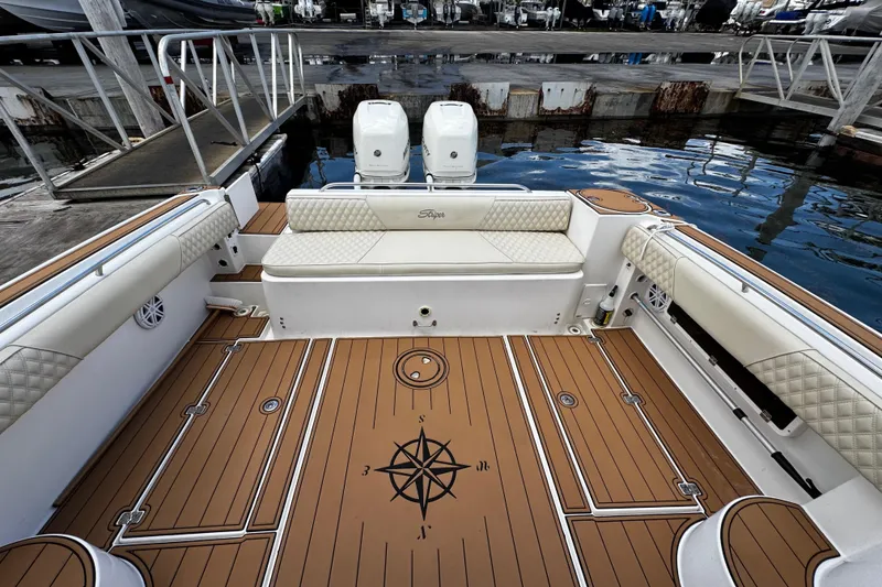 Slide: The Image of 2008 Seaswirl Striper 2901 Walkaround O/B boat interior with cushioned seating and twin engines. - 12