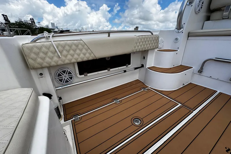 Slide: The Image of 2008 Seaswirl Striper 2901 Walkaround O/B boat interior with cushioned seating and teak flooring. - 14