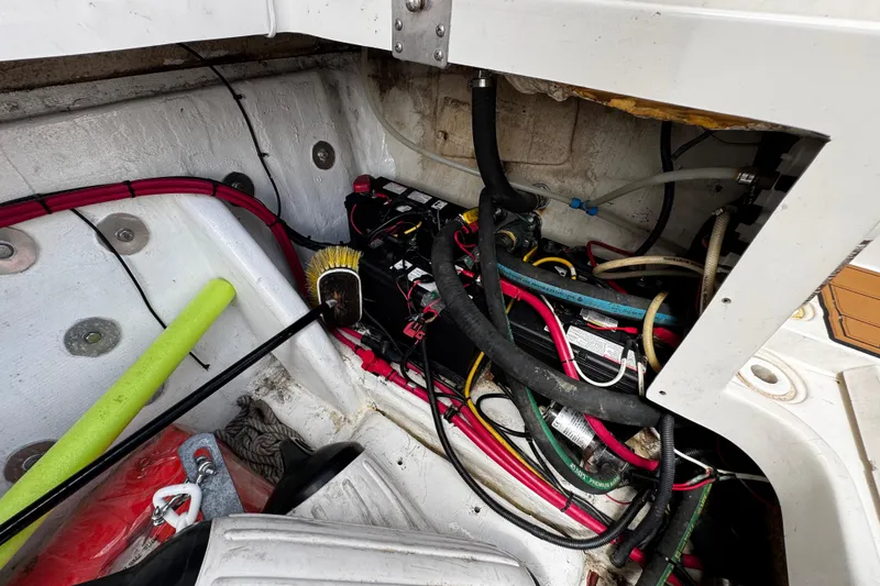 Slide: The Image of 2008 Seaswirl Striper 2901 Walkaround O/B engine compartment with wiring and maintenance tools. - 23