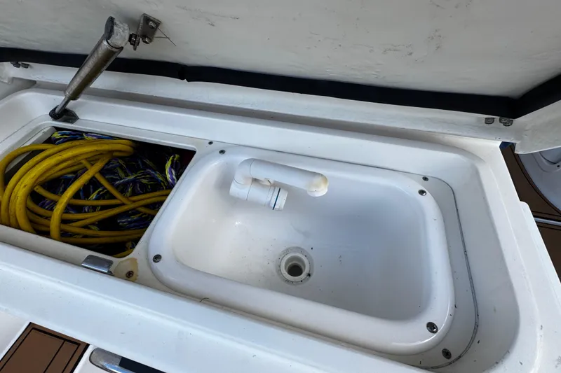 Slide: The Image of 2008 Seaswirl Striper 2901 Walkaround O/B boat sink with yellow rope storage. - 26