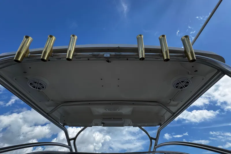 Slide: The Image of 2008 Seaswirl Striper 2901 Walkaround O/B boat roof with rod holders against blue sky. - 27