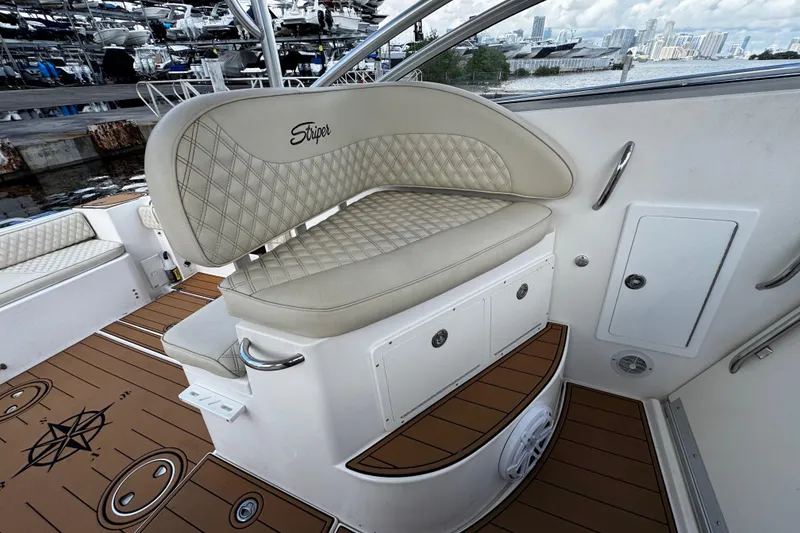 Slide: The Image of 2008 Seaswirl Striper 2901 Walkaround O/B boat interior with cushioned seating and wood-patterned flooring. - 29