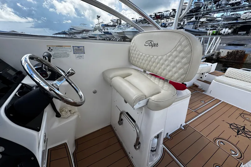 Slide: The Image of 2008 Seaswirl Striper 2901 Walkaround O/B helm with cushioned seat and steering wheel. - 30