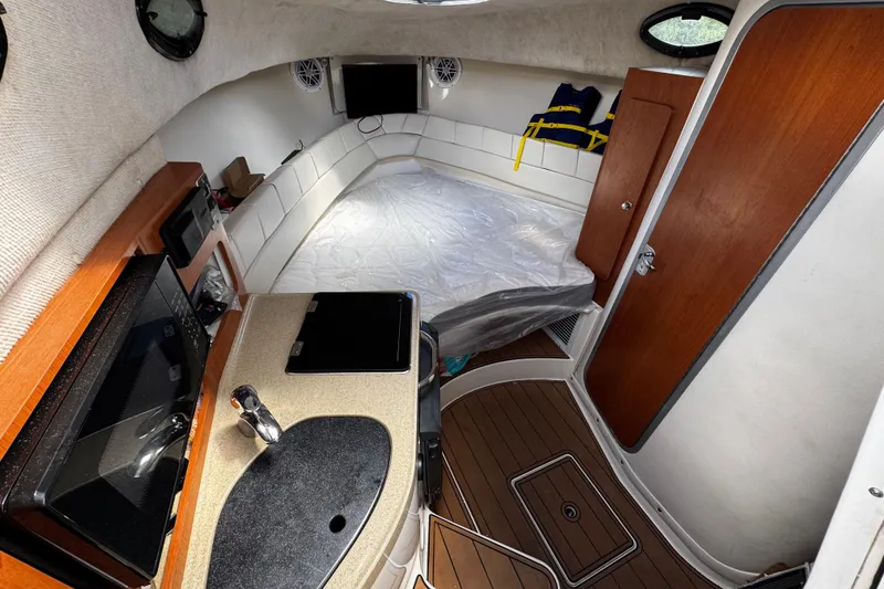 Slide: The Image of 2008 Seaswirl Striper 2901 Walkaround O/B cabin interior with kitchenette and bed. - 36