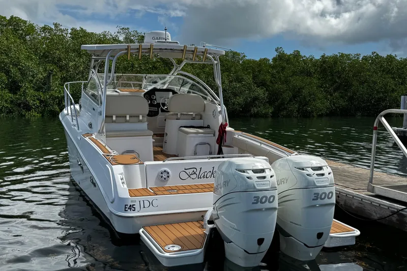 Slide: The Image of 2008 Seaswirl Striper 2901 Walkaround O/B boat docked in marina under cloudy sky. - 4