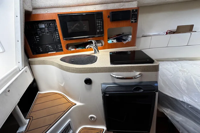 Slide: The Image of 2008 Seaswirl Striper 2901 Walkaround O/B cabin with kitchenette, sink, and microwave. - 40