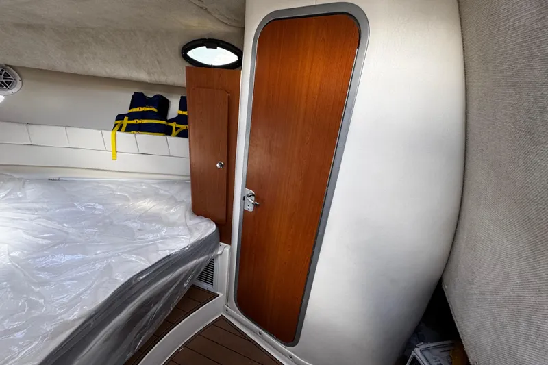 Slide: The Image of 2008 Seaswirl Striper 2901 Walkaround O/B cabin interior with wooden door and life jackets. - 42