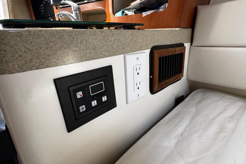 Slide: The Image of 2008 Seaswirl Striper 2901 Walkaround O/B cabin interior with control panel and outlet. - 44