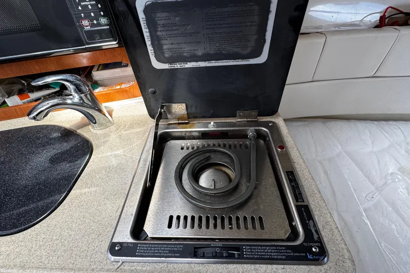 Slide: The Image of 2008 Seaswirl Striper 2901 Walkaround O/B boat kitchen with stove and sink. - 45