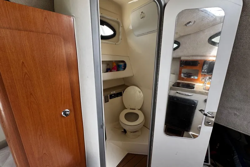Slide: The Image of 2008 Seaswirl Striper 2901 Walkaround O/B boat interior with bathroom and kitchenette. - 46