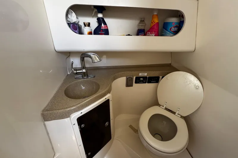 Slide: The Image of 2008 Seaswirl Striper 2901 Walkaround O/B boat bathroom with sink and storage shelves. - 48