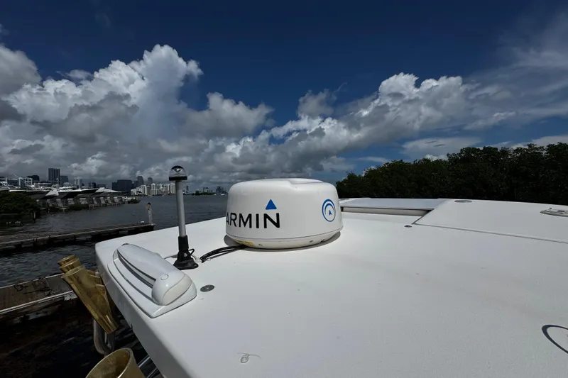 Slide: The Image of 2008 Seaswirl Striper 2901 Walkaround O/B with Garmin radar, docked under cloudy sky. - 52