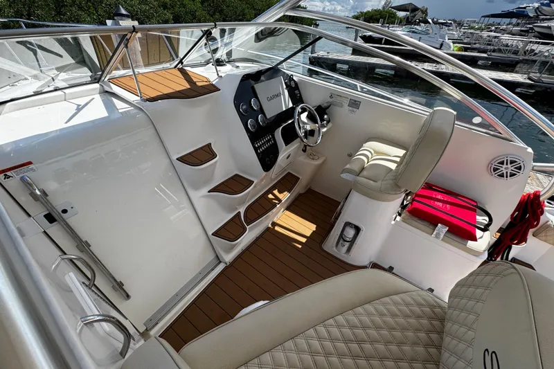 Slide: The Image of 2008 Seaswirl Striper 2901 Walkaround O/B cockpit with helm, seating, and wood accents. - 56