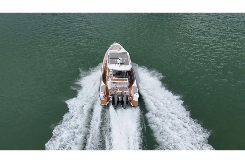 Slide: The Image of Overhead view of 2024 Axopar 37 Sun Top boat on green water. - 10