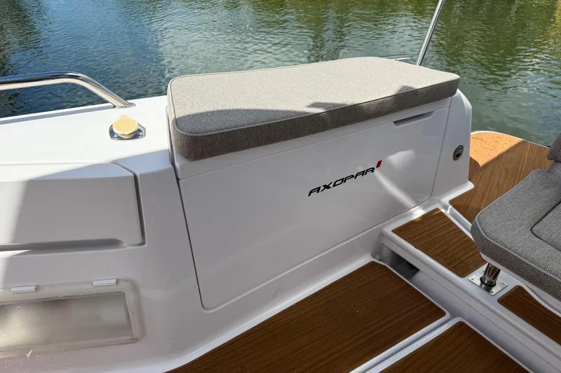 Slide: The Image of 2024 Axopar 37 Sun Top boat seats with sleek design and wooden deck. - 16