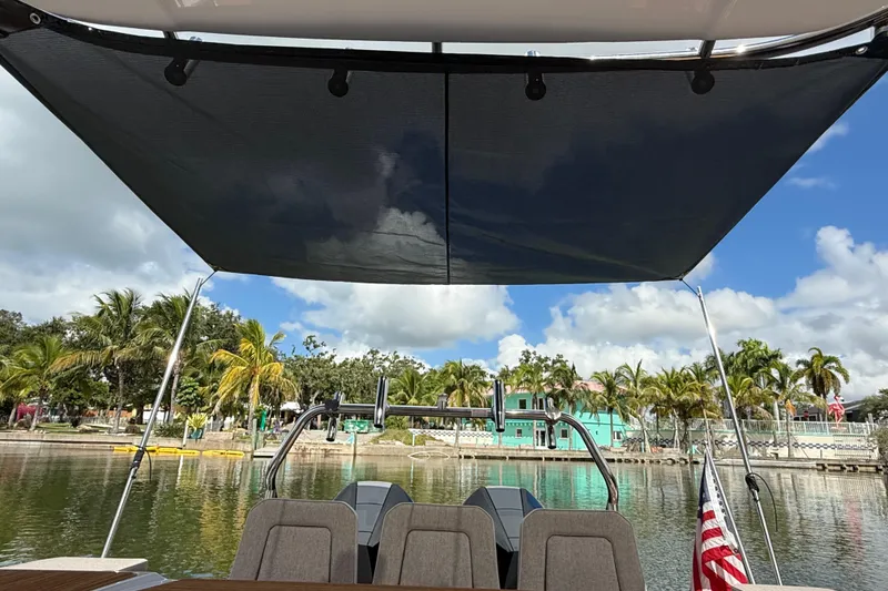 Slide: The Image of Twin Mercury outboard engines on a 2024 Axopar 37 Sun Top boat. - 19