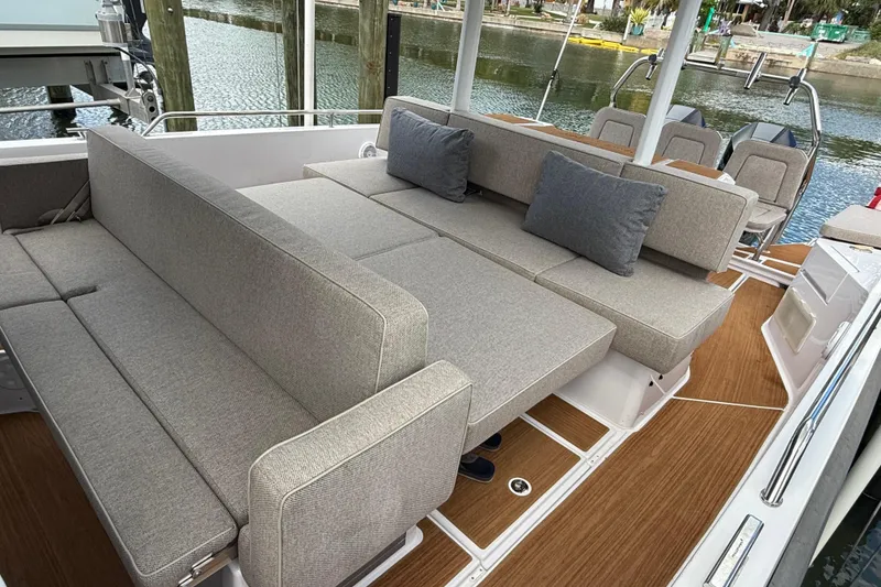 Slide: The Image of Open storage compartments on 2024 Axopar 37 Sun Top boat, containing nautical gear. - 23