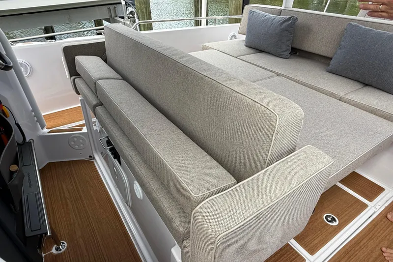 Slide: The Image of 2024 Axopar 37 Sun Top boat interior with spacious seating and wooden flooring. - 24