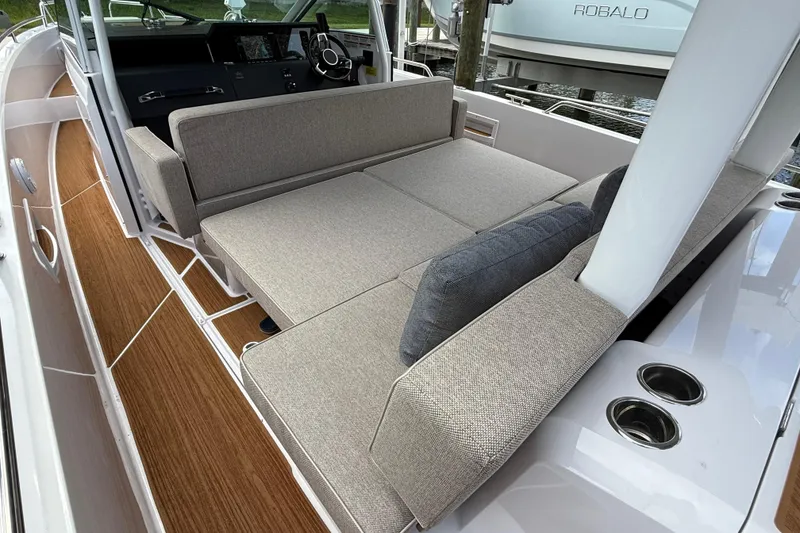 Slide: The Image of 2024 Axopar 37 Sun Top boat with comfortable gray seating and cushions. - 28