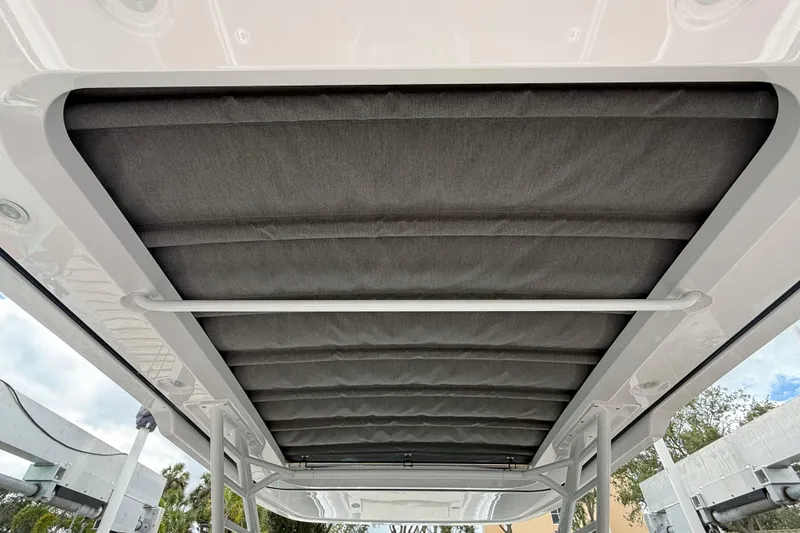 Slide: The Image of 2024 Axopar 37 Sun Top boat interior with elegant seating and modern table design. - 32