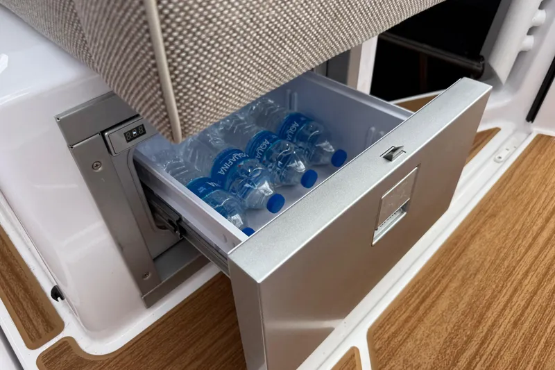 Slide: The Image of 2024 Axopar 37 Sun Top interior with teak flooring and cushioned seating. - 34