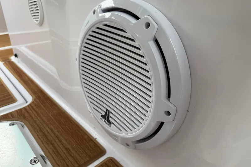 Slide: The Image of 2024 Axopar 37 Sun Top boat fridge with water bottles on teak deck. - 35