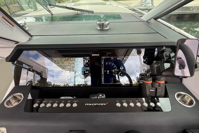 Slide: The Image of 2024 Axopar 37 Sun Top helm with advanced navigation and control systems. - 39