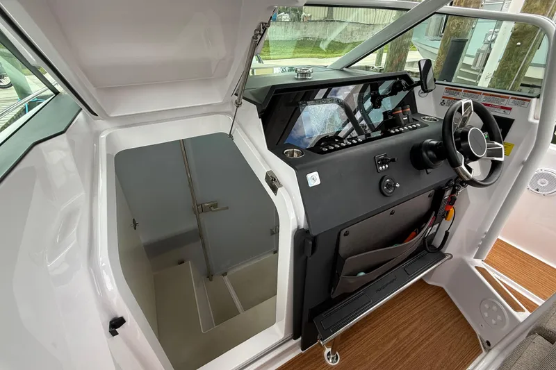 Slide: The Image of Control panel of 2024 Axopar 37 Sun Top with Simrad device and keys. - 41