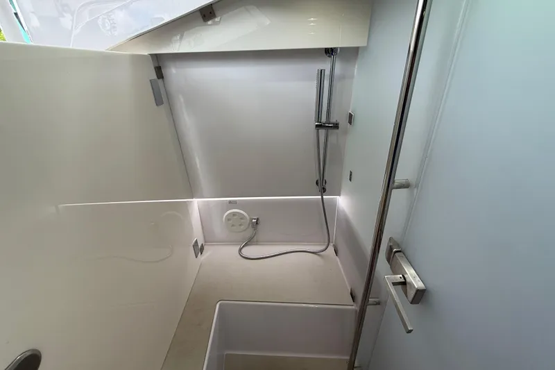 Slide: The Image of Small sink with running water and soap dispenser on Axopar 37 Sun Top, 2024 model. - 45