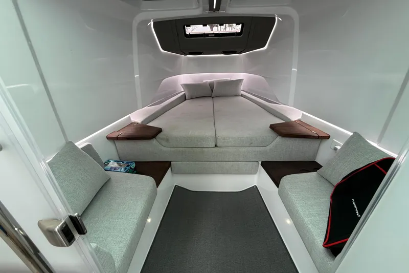 Slide: The Image of 2024 Axopar 37 Sun Top cabin interior with modern seating and cozy bed. - 47