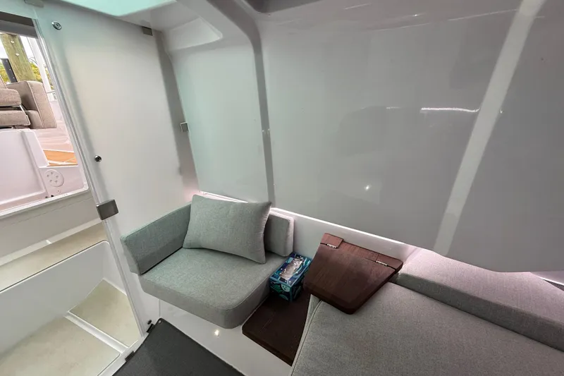 Slide: The Image of 2024 Axopar 37 Sun Top interior with modern seating and sleek design. - 50