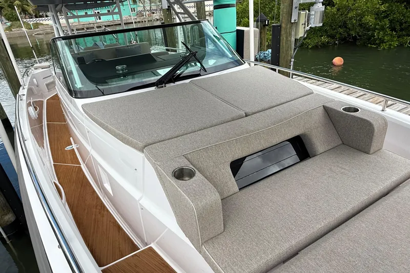 Slide: The Image of 2024 Axopar 37 Sun Top boat with cushioned deck seating and sleek design. - 53