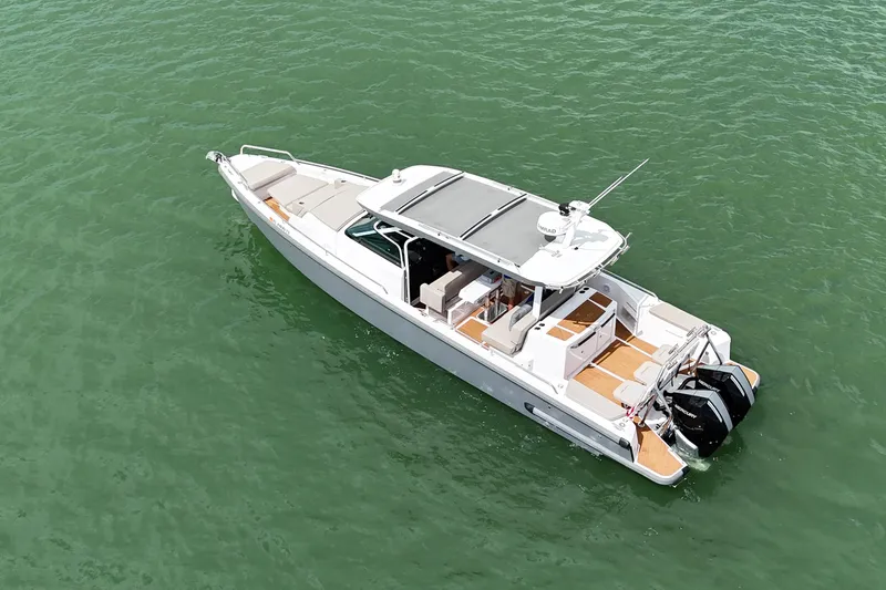 Slide: The Image of 2024 Axopar 37 Sun Top boat cruising on open water. - 6