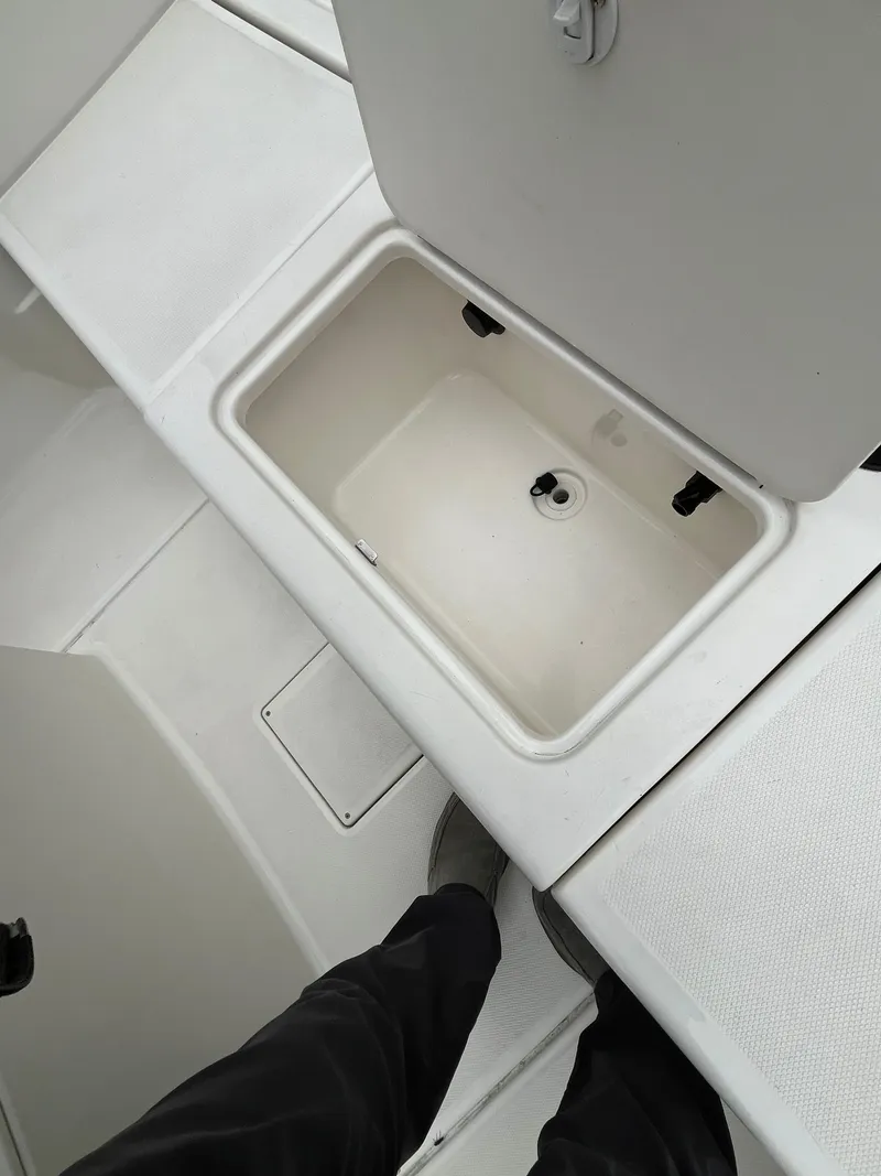 Slide: The Image of 2021 Bayliner Trophy boat storage compartment with open lid, showcasing interior space. - 10