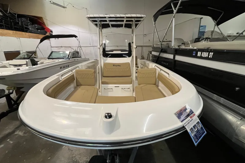 Slide: The Image of 2021 Trophy T22 CC boat with beige seating, displayed indoors. - 15