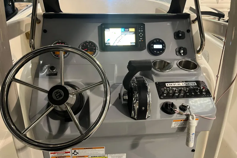 Slide: The Image of 2021 Trophy T22 CC boat dashboard with steering wheel, controls, and navigation display. - 17