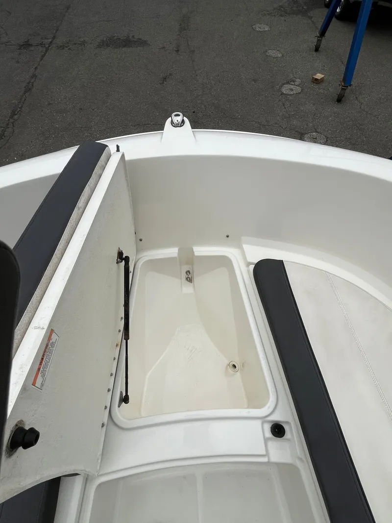 Slide: The Image of 2021 Bayliner Trophy boat interior with open storage compartment and seating. - 8